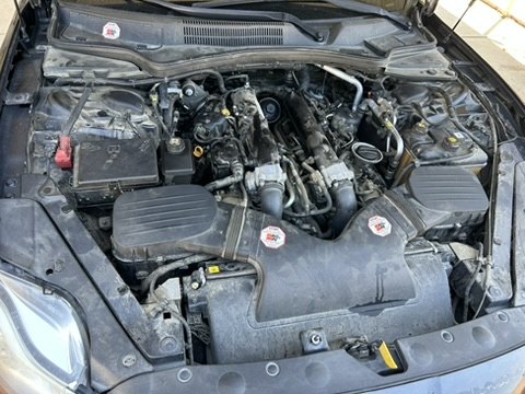 Before — Engine bay cleaned by hand — grime and dust gone.